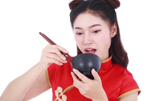 happy woman wearing chinese cheongsam dress with chopsticks and bowl isolated on a white background