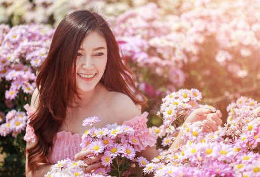 beautiful woman in colorful chrysanthemum glower garden 