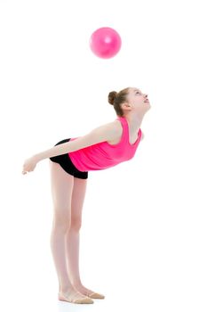 A charming little girl is engaged in fitness with a ball. The concept of gymnastics, health and sports. Isolated on white background.