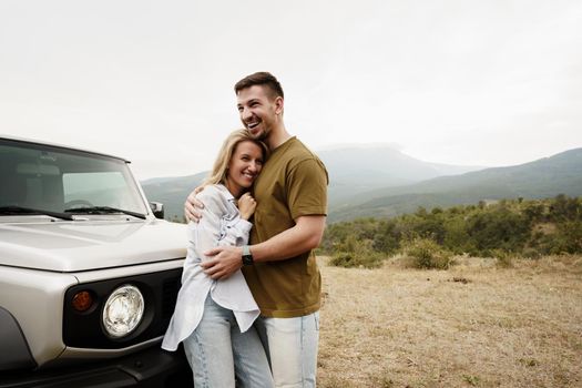 Young couple is on romantic trip to the mountains by car, close up