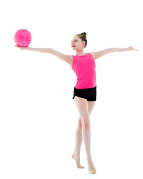 A charming little girl is engaged in fitness with a ball. The concept of gymnastics, health and sports. Isolated on white background.