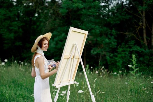 pretty woman in white dress outdoors drawing art creative. High quality photo