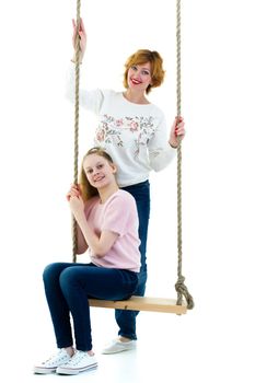Happy mom and daughter swing on a swing. The concept of family happiness, parenting. Isolated on white background.