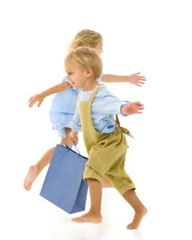 Boy and girl, brother and sister posing in the studio. Concept of family values, friendship, game. Isolated on white background