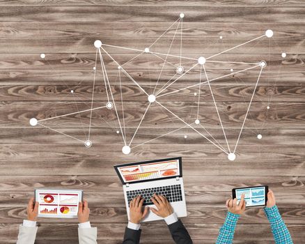 Group of three people with devices in hands working together as symbol of networking and communication