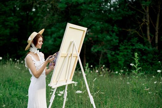 pretty woman in white dress outdoors drawing art creative. High quality photo