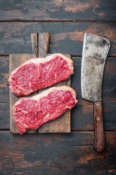 Veiny steak, marbled beef raw meat, on dark wooden background, top view