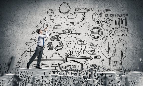 Businessman playing fife while standing on pile of documents among flying letters with eco-analytical information on background. Mixed media.