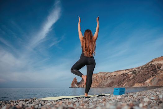 Group of young womans fitness instructor in Sportswear Leggings and Tops, stretching in the gym before pilates, on a yoga mat near the large window on a sunny day, female fitness yoga routine concept.