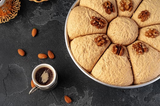 Turkish dessert baklava with nuts on black background, close up