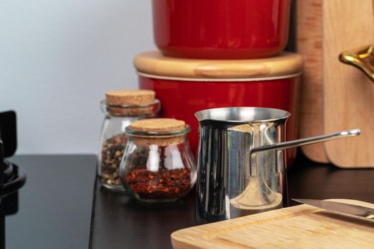 Brewed coffee in a metal turk on a kitchen counter close up