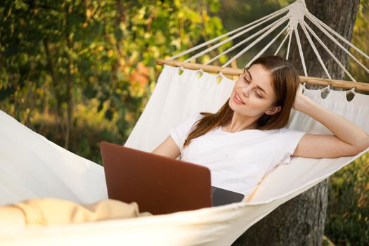 woman love with laptop on nature vacation work travel. High quality photo