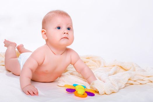 Cute baby girl on white background. Baby in diaper with toy