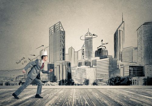 Young handsome businessman wearing white paper crown running in a hurry
