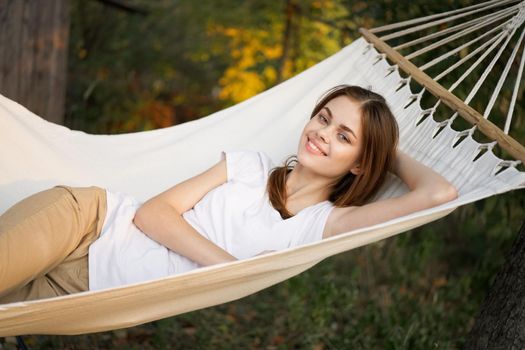cheerful woman lies in a hammock rest nature fresh air. High quality photo
