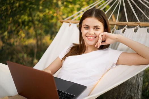 woman love with laptop on nature vacation work travel. High quality photo