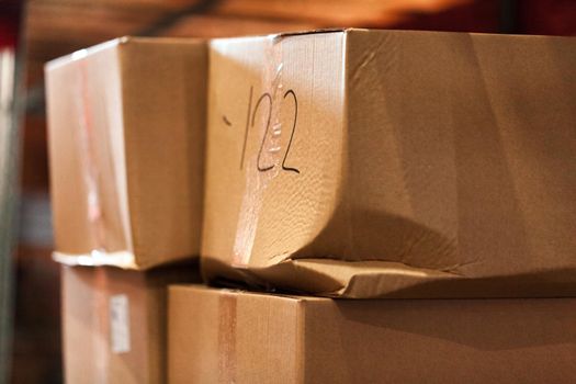 Modern warehouse shelves with pile of cardboard boxes. Close up.