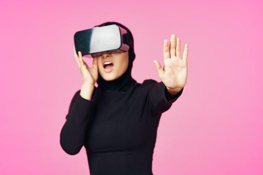 muslim woman wearing virtual reality glasses entertainment technology device. High quality photo