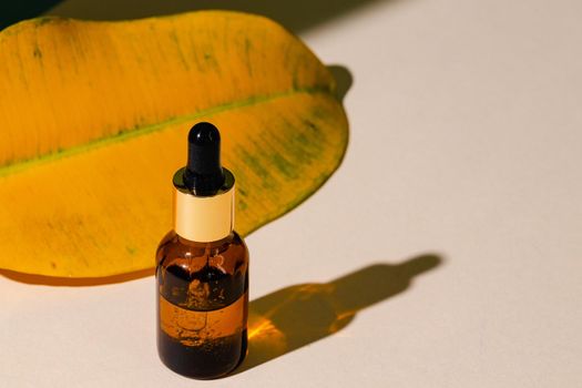 Oily skincare moistrizing brown glass jar with pipette close up