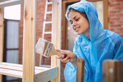 woman painter painting wood home renovation texture. High quality photo