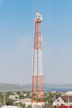 Radio global Internet tower of mobile communication telecommunication against the background of blue sky.