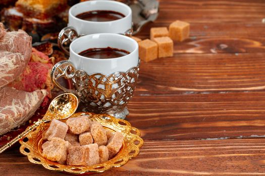 Two cups of coffee with traditional turkish desserts, close up