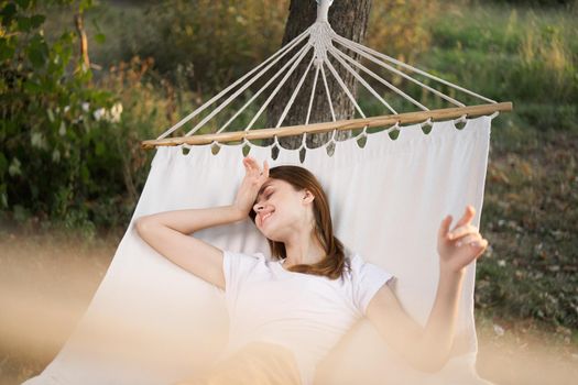woman relaxing in nature in a hammock garden fresh air. High quality photo