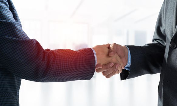 A close-up of a handshake. Making a deal between two businessmen