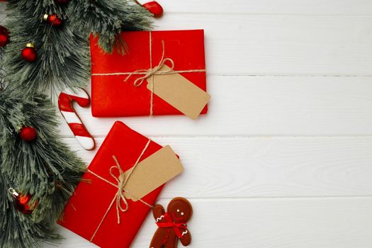 Christmas present and festive gingerbread cookies on wooden background top view