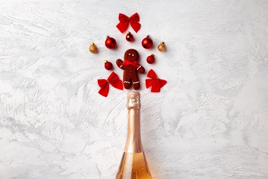 Golden champagne bottle with Christmas gingerbread flatlay top view