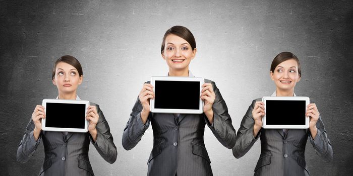 Women stand in a row. demonstrate computer tablets with cope space.