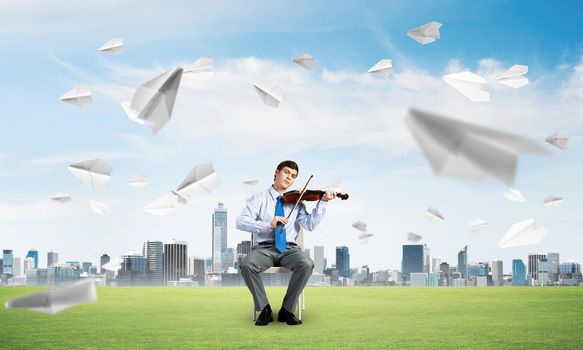 young businessman is engaged in music, concept of creative chaos in business