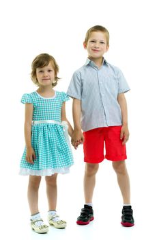 Boy and girl, brother and sister posing in the studio. Concept of family values, friendship, game. Isolated on white background