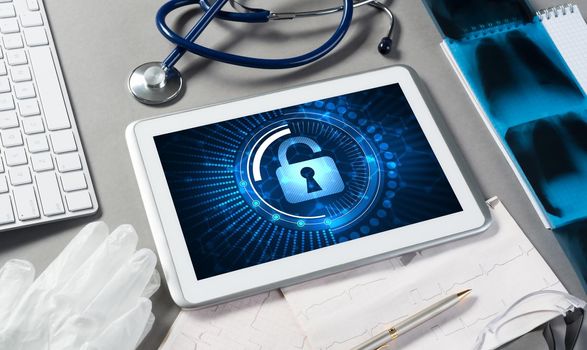 Doctors workplace with white tablet stethoscope and mask