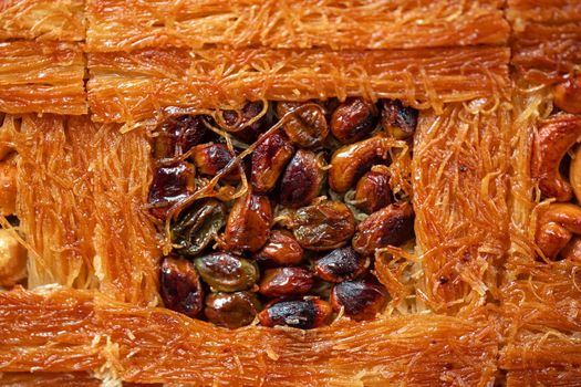 Close up photo of Turkish Baklava dessert with honey and nuts