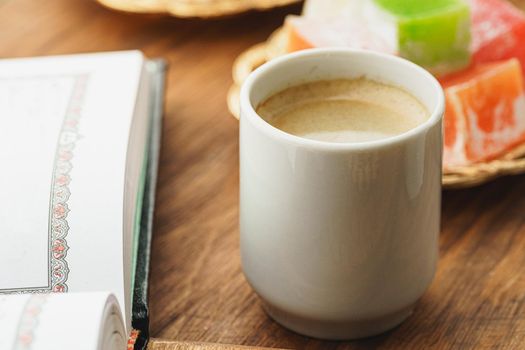 Coffee cup with oriental sweets on wooden table close up