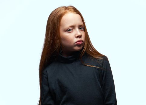 red-haired girl in a black sweater planning close-up. High quality photo