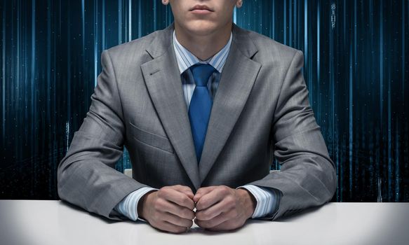 Man with folded hands sitting at desk. Internet manager without face in business suit and tie on abstract matrix like background. Digital technologies and innovations. Internet company service