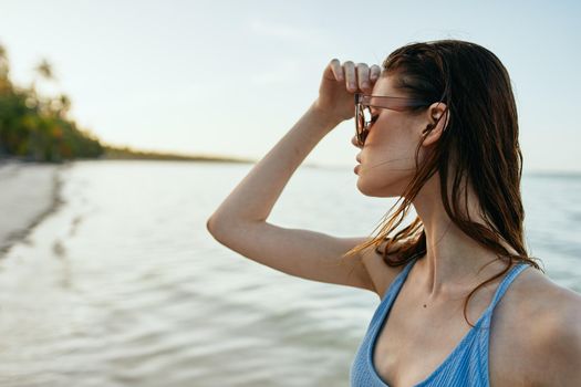 woman wearing sunglasses blue swimsuit island beach sun. High quality photo