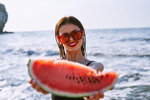 cheerful pretty woman in black swimsuit watermelon fashion travel. High quality photo
