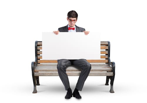 Young businessman holds a large white banner. sits on the bench
