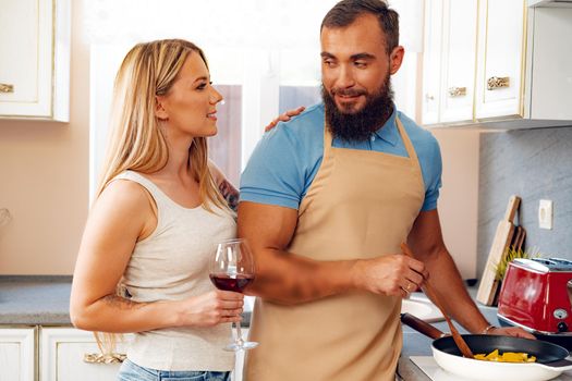 Couple in love preparing meal together in kitchen at home