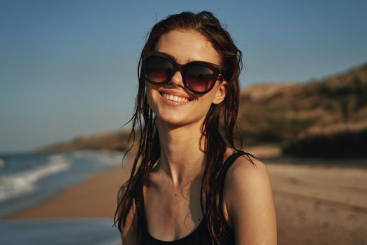 pretty woman in black swimsuit beach nature sun. High quality photo