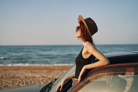woman on the beach near car travel adventure summer. High quality photo