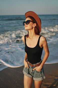 woman walking on the beach hat travel vacation sun. High quality photo