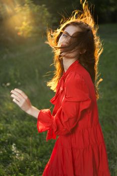 woman in red dress posing nature sun fun. High quality photo