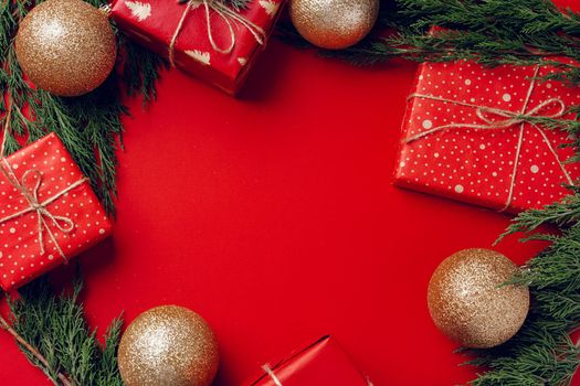 Red festive Christmas background with coniferous branches, copy space