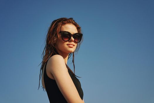 woman in black swimsuit sunglasses sun nature. High quality photo