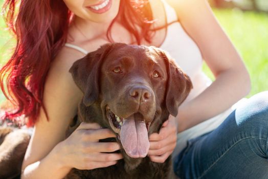 Woman in the park hugs a dog. Spend time with pets