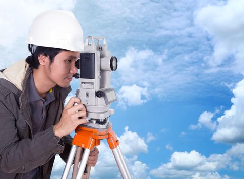 engineer working with survey equipment theodolite with blue sky background